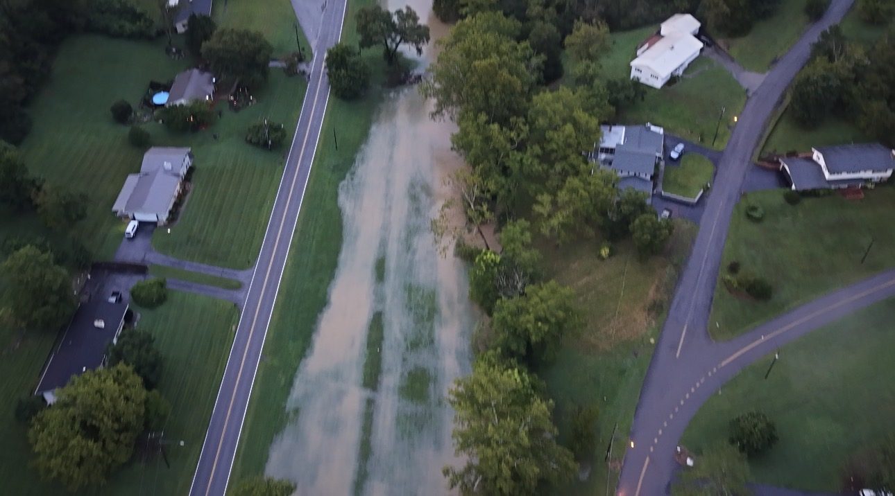 Aerial view of a flooded field and washed-over right-of-way between two rural roads