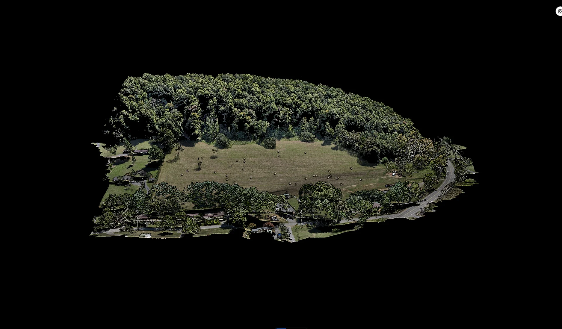 Aerial 3D reconstruction showing terrain, open space, and wooded surroundings